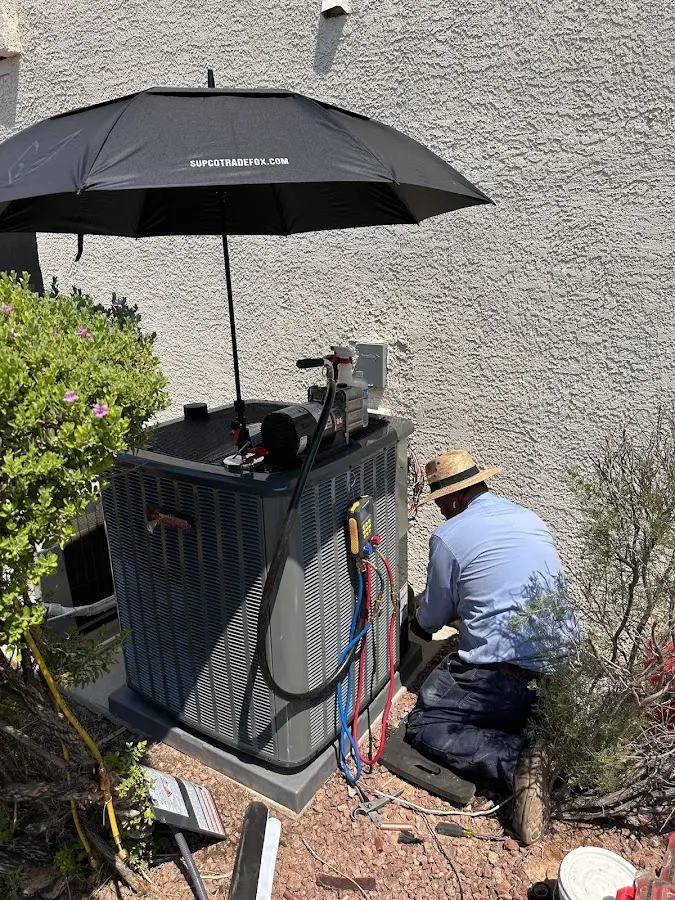 HVAC technician performing outdoor AC maintenance in Burlington